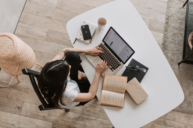 A picture containing floor, person, desk Description automatically generated