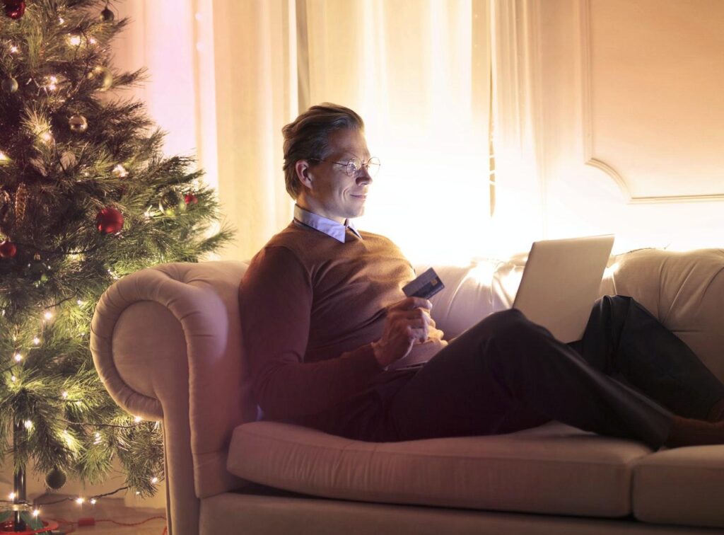 A person sitting on a couch Description automatically generated with low confidence