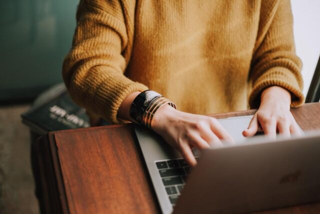 A business professional using a laptop to visualize data on a web chart.