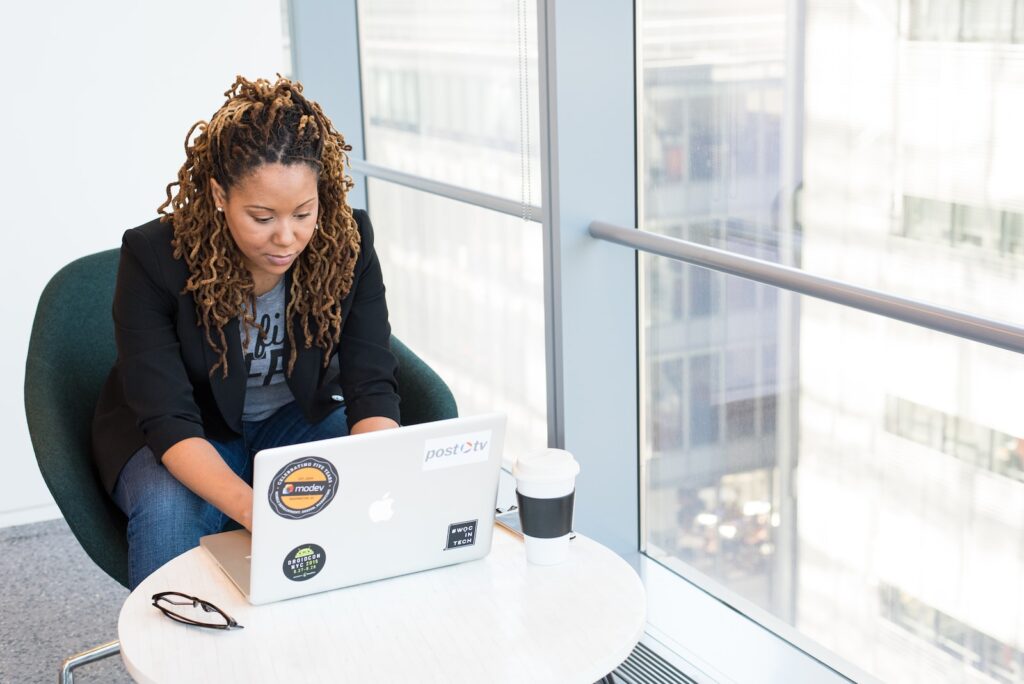 Businesswoman looking over analytics for sales bookings on laptop