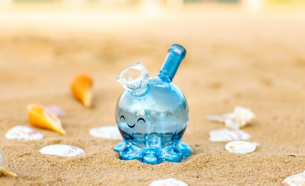 blue glass bottle on brown sand