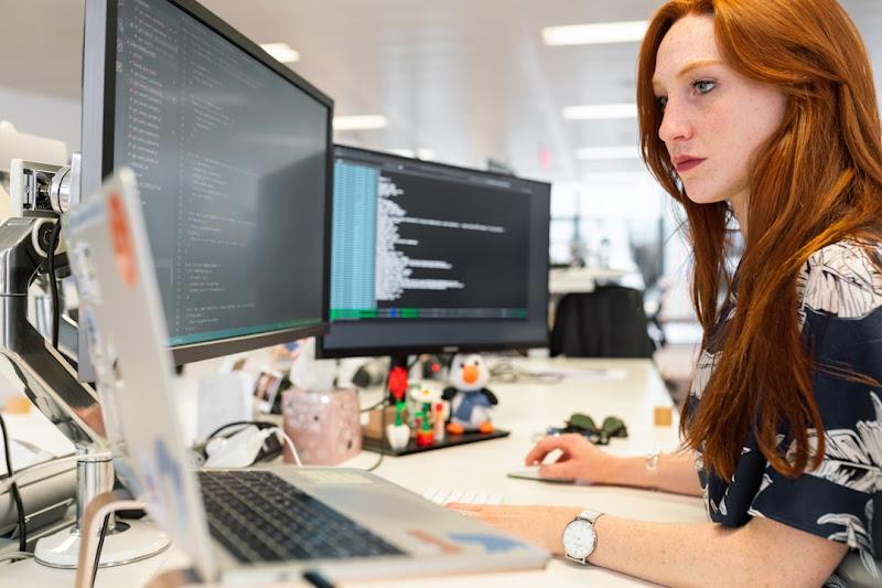 A woman in an office researching organizational knowledge management during a meeting