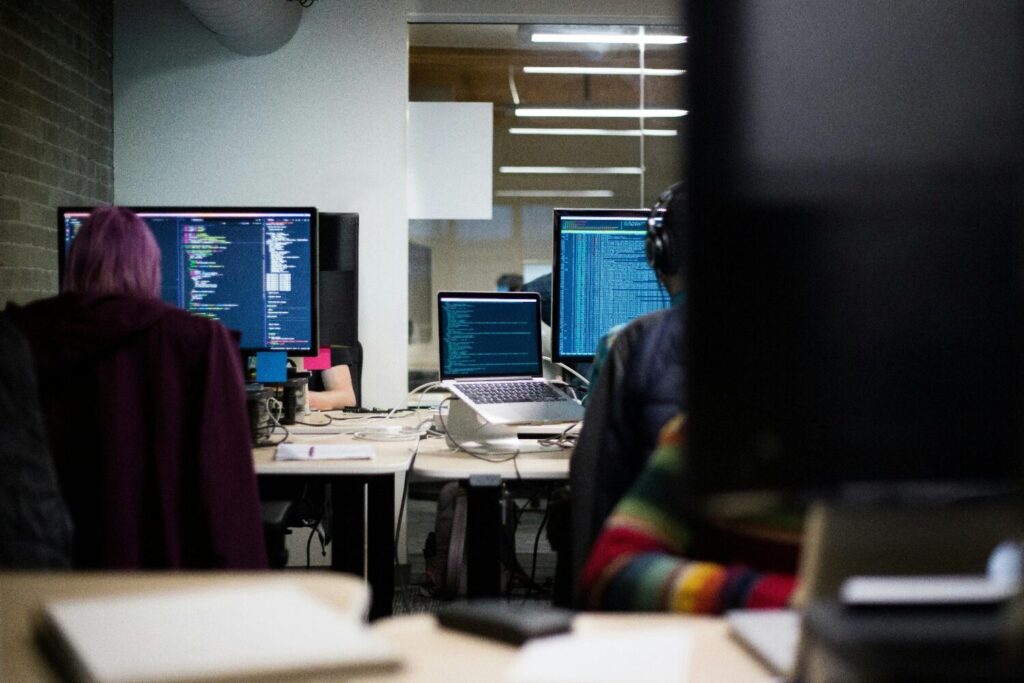 people sitting at desks with computers