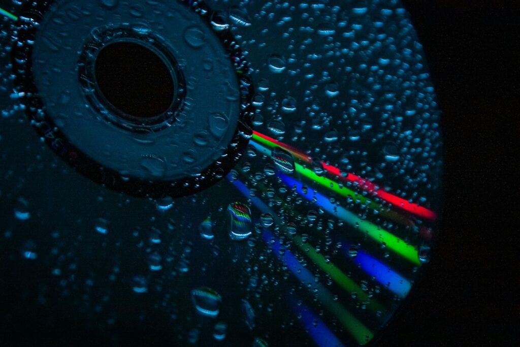 a close up of a cd with water droplets on it