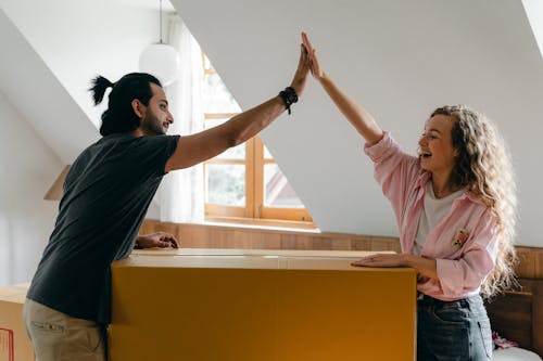 Free Exited diverse couple relocating in new apartment Stock Photo