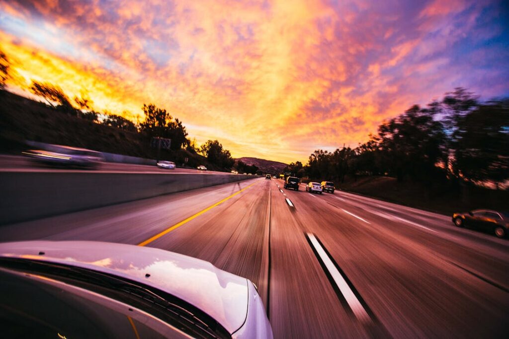Free Motion blur of cars speeding on an Irvine highway at sunset with vibrant skies. Stock Photo